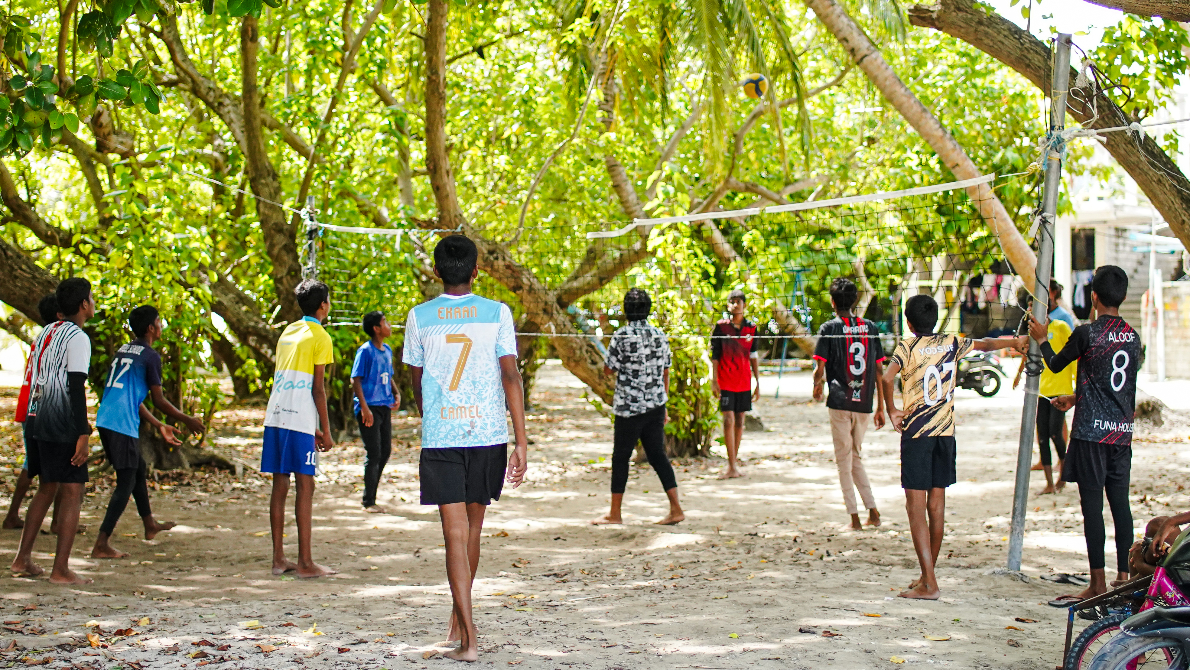 A group of boys playing volleyball at F. Feeali