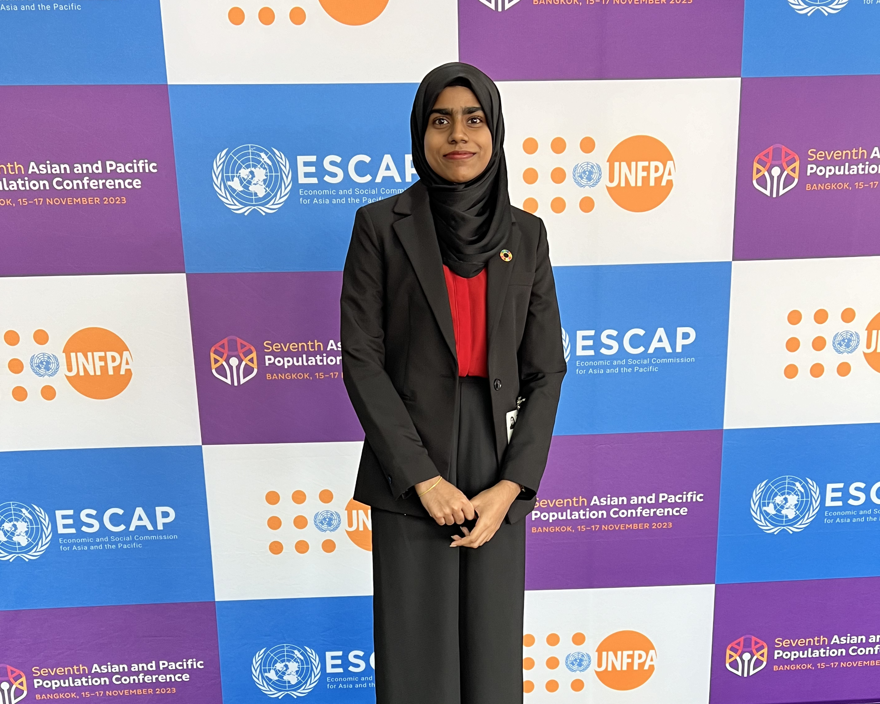  Shuba poses for a picture in front of the logo backdrop on the first day of the 7th APPC. © Shuba Minhaj