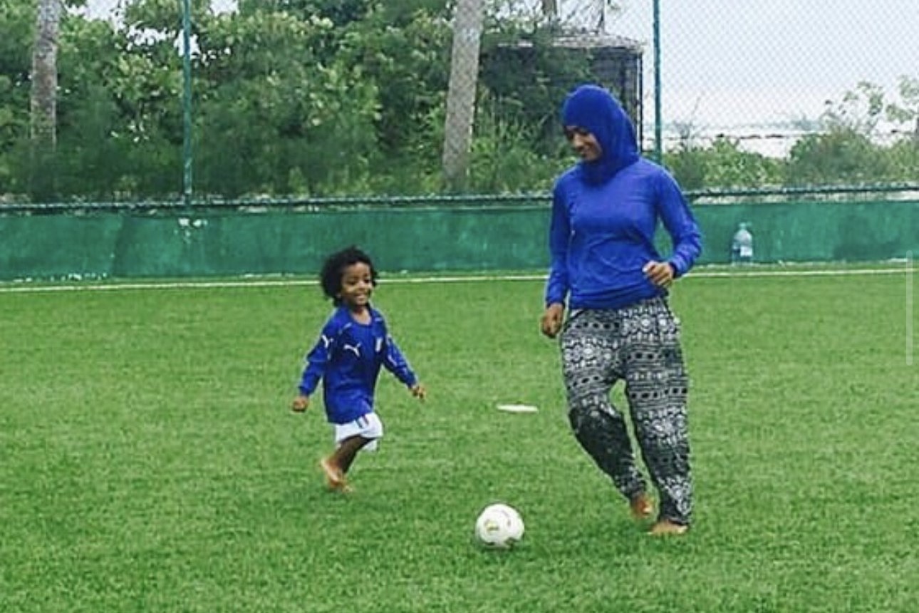 Shaliya playing football with her son. © Shaliya