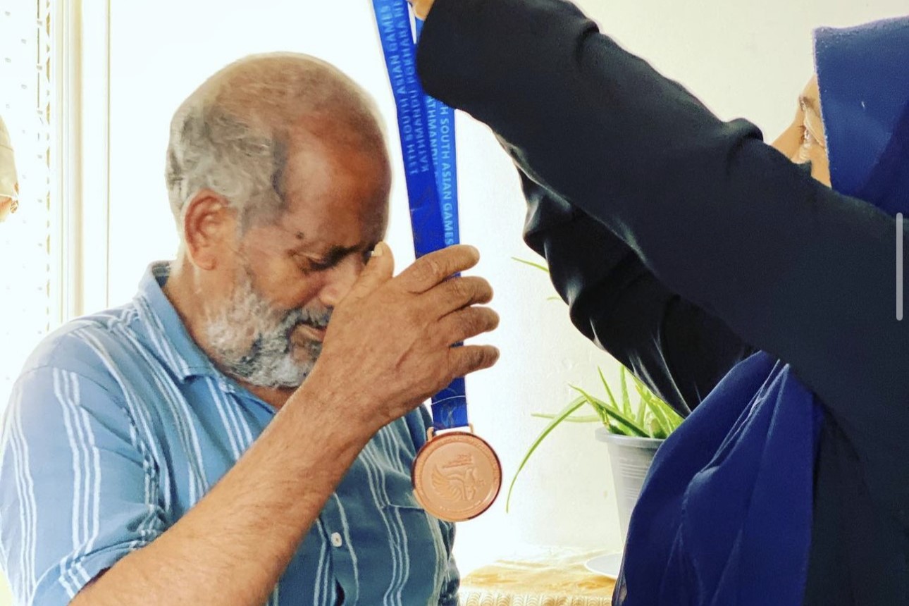 Shaliya gives her parents the bronze medal she won at the 2019 South Asian Games. © Shaliya