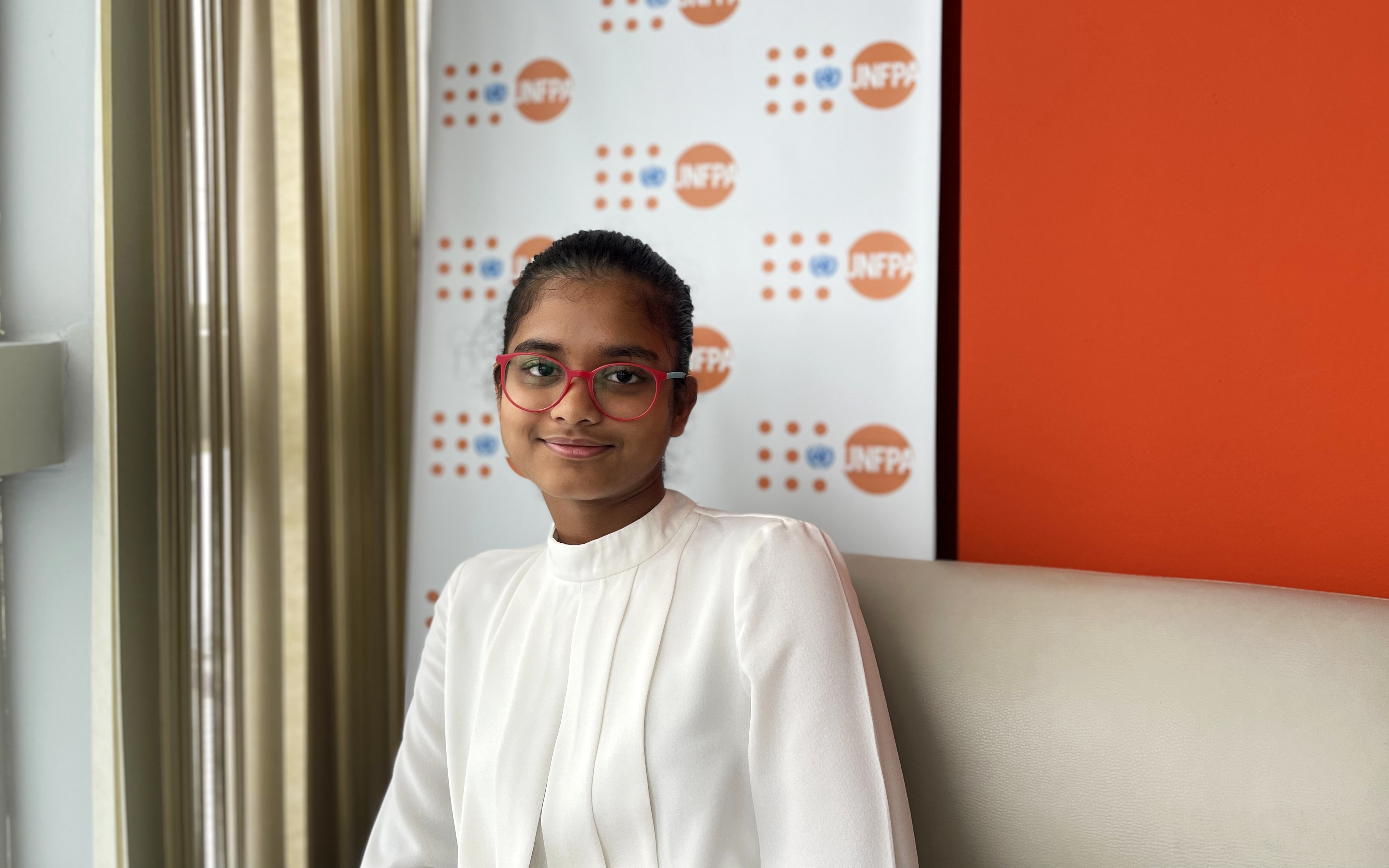 Imani's smile reflects the pride and hope of youth, capturing the spirit of her day at UNFPA where her voice and vision found a platform to inspire others