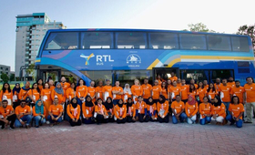 Partners and UN Family posing in front of MTCC Bus