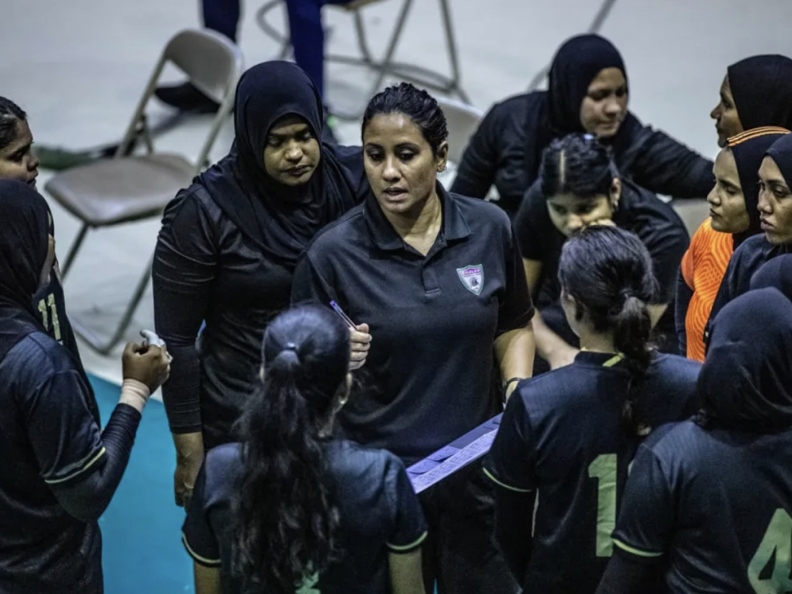 Strategizing Success. Coach Muna in a huddle, instilling focus and fire in her team during the Association Cup 2022. © Adhadhu News via Muna